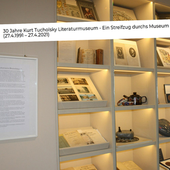 Section of an illuminated archive shelf with small exhibits